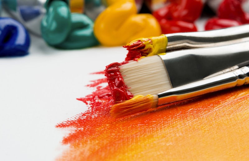 Mature student painting at an easel in a bright art studio