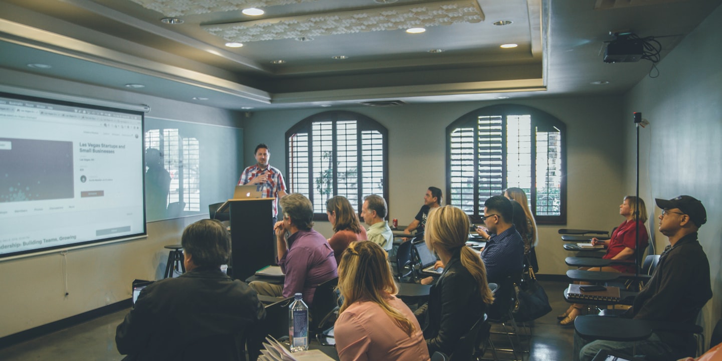 Mature adults engaged in a thoughtful group discussion at a learning workshop